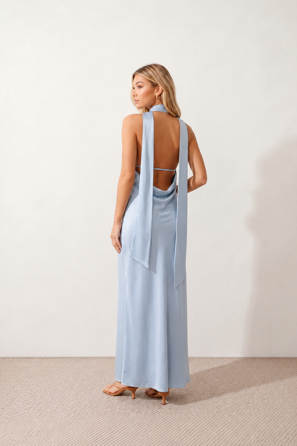Aleena cowl neck halter maxi dress with a deep draped neckline, fitted halter strap, open back with tie-neck closure, sleeveless column silhouette, and floor-length straight hem in a smooth, elegant finish.