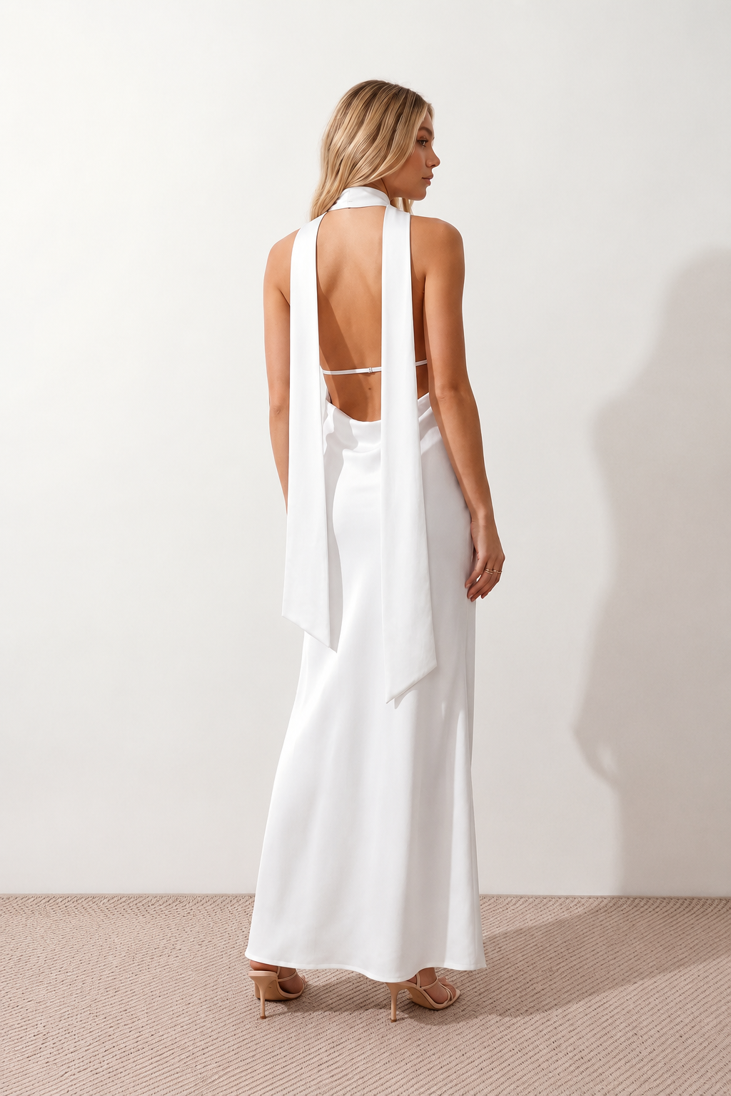 Aleena cowl neck halter maxi dress with a deep draped neckline, fitted halter strap, open back with tie-neck closure, sleeveless column silhouette, and floor-length straight hem in a smooth, elegant finish.