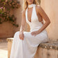 Aleena cowl neck halter maxi dress with a deep draped neckline, fitted halter strap, open back with tie-neck closure, sleeveless column silhouette, and floor-length straight hem in a smooth, elegant finish.