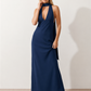 Aleena cowl neck halter maxi dress with a deep draped neckline, fitted halter strap, open back with tie-neck closure, sleeveless column silhouette, and floor-length straight hem in a smooth, elegant finish.