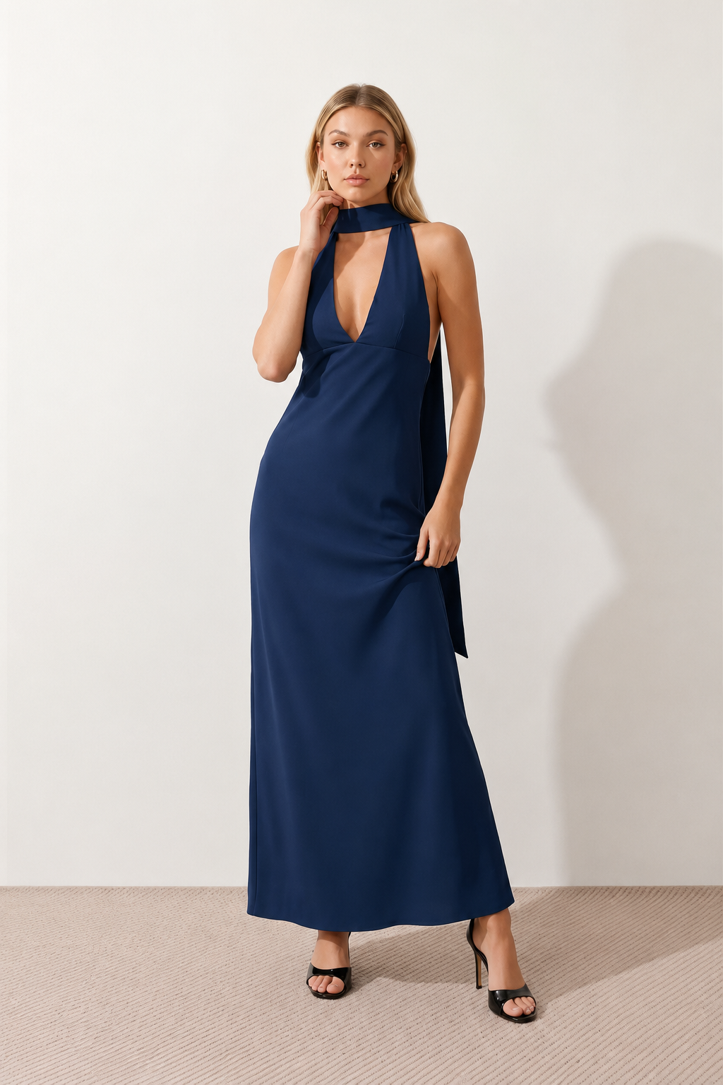 Aleena cowl neck halter maxi dress with a deep draped neckline, fitted halter strap, open back with tie-neck closure, sleeveless column silhouette, and floor-length straight hem in a smooth, elegant finish.