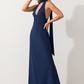 Aleena cowl neck halter maxi dress with a deep draped neckline, fitted halter strap, open back with tie-neck closure, sleeveless column silhouette, and floor-length straight hem in a smooth, elegant finish.