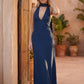 Aleena cowl neck halter maxi dress with a deep draped neckline, fitted halter strap, open back with tie-neck closure, sleeveless column silhouette, and floor-length straight hem in a smooth, elegant finish.