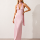 Aleena cowl neck halter maxi dress with a deep draped neckline, fitted halter strap, open back with tie-neck closure, sleeveless column silhouette, and floor-length straight hem in a smooth, elegant finish.