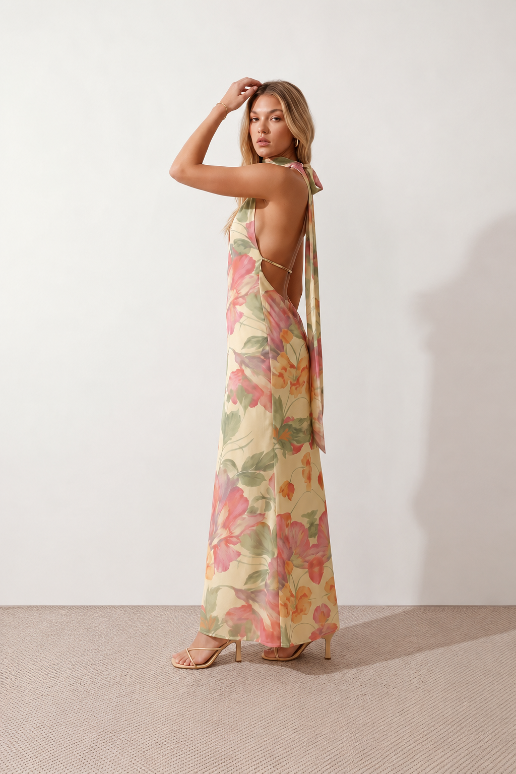 Aleena cowl neck halter maxi dress with a deep draped neckline, fitted halter strap, open back with tie-neck closure, sleeveless column silhouette, and floor-length straight hem in a smooth, elegant finish.