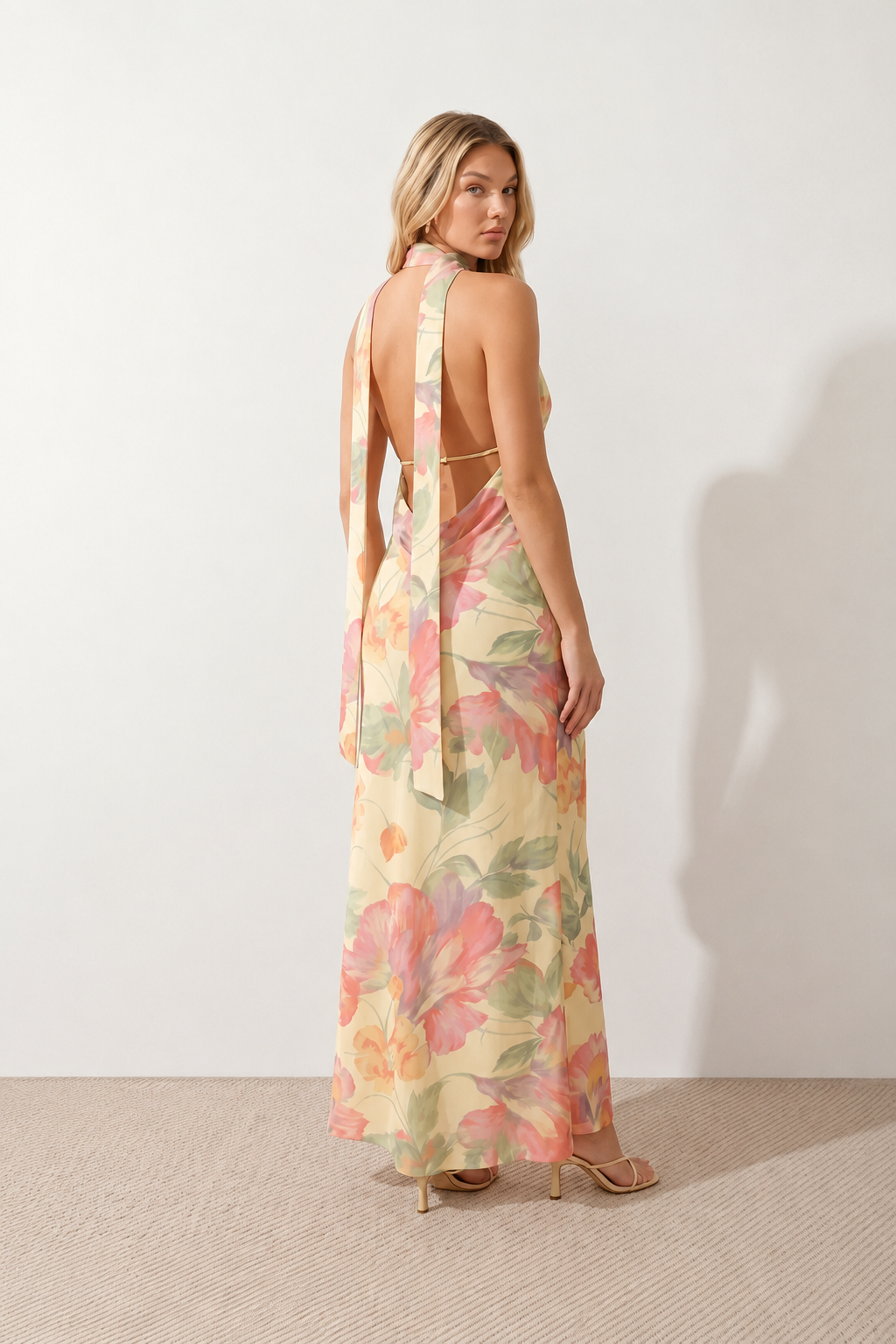 Aleena cowl neck halter maxi dress with a deep draped neckline, fitted halter strap, open back with tie-neck closure, sleeveless column silhouette, and floor-length straight hem in a smooth, elegant finish.