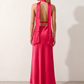 Aleena cowl neck halter maxi dress with a deep draped neckline, fitted halter strap, open back with tie-neck closure, sleeveless column silhouette, and floor-length straight hem in a smooth, elegant finish.