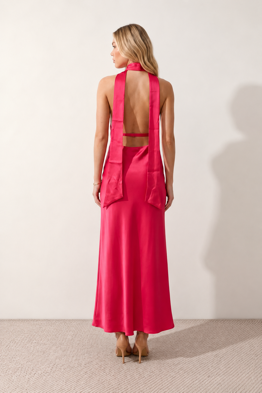 Aleena cowl neck halter maxi dress with a deep draped neckline, fitted halter strap, open back with tie-neck closure, sleeveless column silhouette, and floor-length straight hem in a smooth, elegant finish.