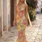 Aleena cowl neck halter maxi dress with a deep draped neckline, fitted halter strap, open back with tie-neck closure, sleeveless column silhouette, and floor-length straight hem in a smooth, elegant finish.