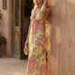 Aleena cowl neck halter maxi dress with a deep draped neckline, fitted halter strap, open back with tie-neck closure, sleeveless column silhouette, and floor-length straight hem in a smooth, elegant finish.