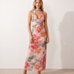 Aleena cowl neck halter maxi dress with a deep draped neckline, fitted halter strap, open back with tie-neck closure, sleeveless column silhouette, and floor-length straight hem in a smooth, elegant finish.