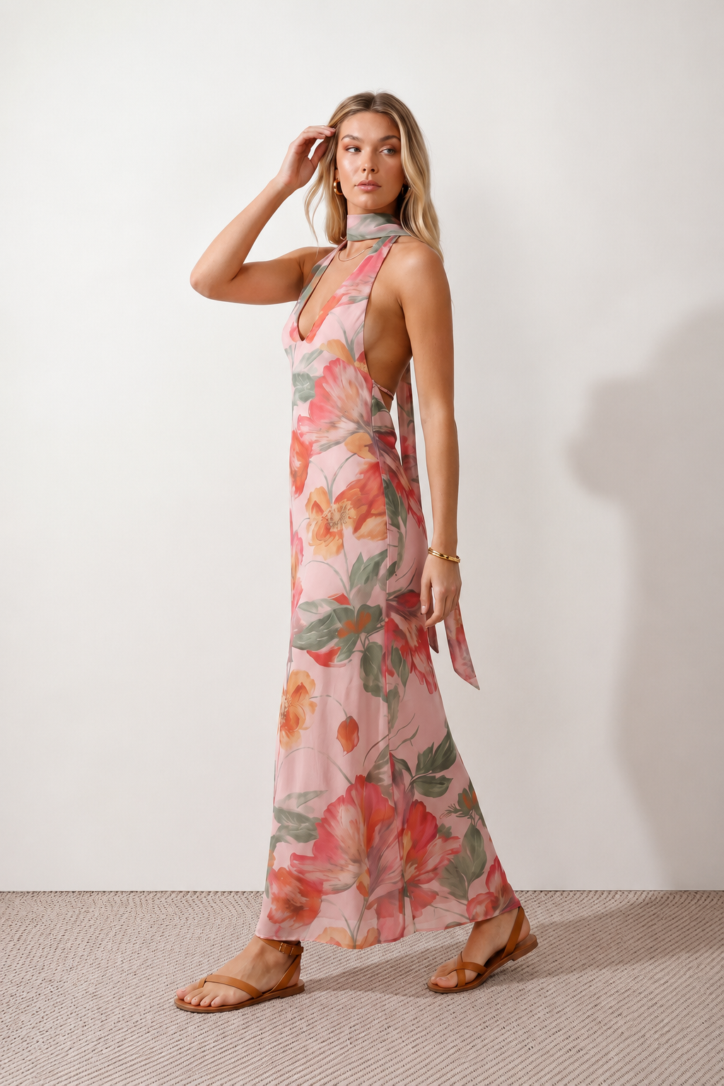 Aleena cowl neck halter maxi dress with a deep draped neckline, fitted halter strap, open back with tie-neck closure, sleeveless column silhouette, and floor-length straight hem in a smooth, elegant finish.