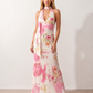 Aleena cowl neck halter maxi dress with a deep draped neckline, fitted halter strap, open back with tie-neck closure, sleeveless column silhouette, and floor-length straight hem in a smooth, elegant finish.