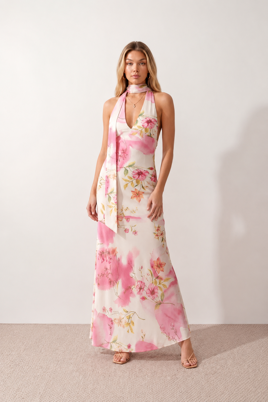 Aleena cowl neck halter maxi dress with a deep draped neckline, fitted halter strap, open back with tie-neck closure, sleeveless column silhouette, and floor-length straight hem in a smooth, elegant finish.