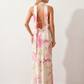 Aleena cowl neck halter maxi dress with a deep draped neckline, fitted halter strap, open back with tie-neck closure, sleeveless column silhouette, and floor-length straight hem in a smooth, elegant finish.