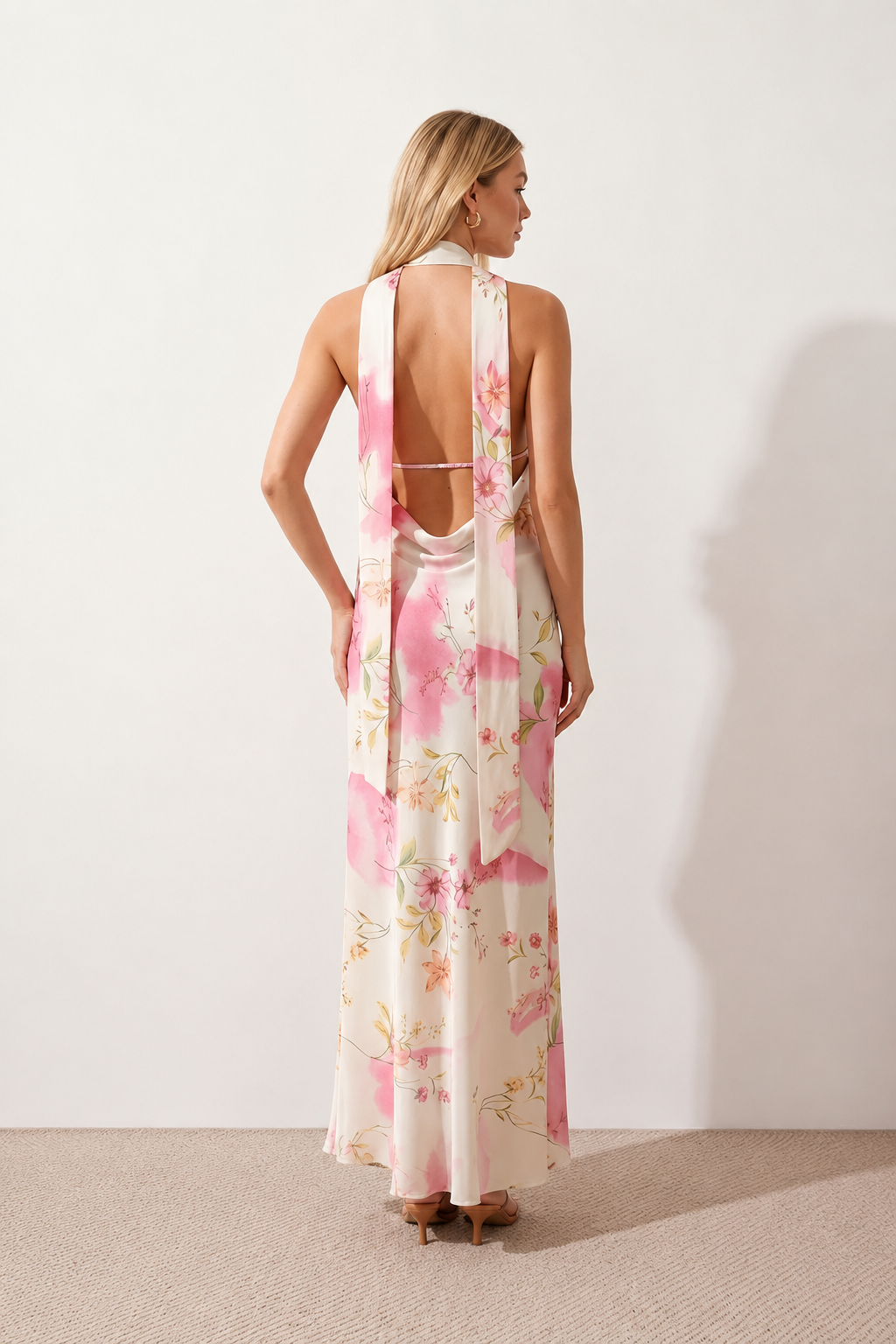 Aleena cowl neck halter maxi dress with a deep draped neckline, fitted halter strap, open back with tie-neck closure, sleeveless column silhouette, and floor-length straight hem in a smooth, elegant finish.