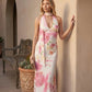 Aleena cowl neck halter maxi dress with a deep draped neckline, fitted halter strap, open back with tie-neck closure, sleeveless column silhouette, and floor-length straight hem in a smooth, elegant finish.