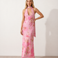 Aleena cowl neck halter maxi dress with a deep draped neckline, fitted halter strap, open back with tie-neck closure, sleeveless column silhouette, and floor-length straight hem in a smooth, elegant finish.