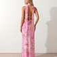 Aleena cowl neck halter maxi dress with a deep draped neckline, fitted halter strap, open back with tie-neck closure, sleeveless column silhouette, and floor-length straight hem in a smooth, elegant finish.