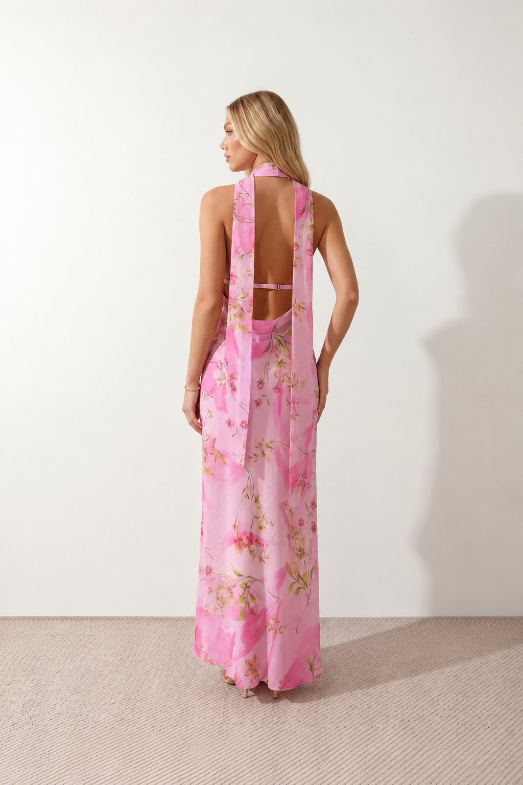Aleena cowl neck halter maxi dress with a deep draped neckline, fitted halter strap, open back with tie-neck closure, sleeveless column silhouette, and floor-length straight hem in a smooth, elegant finish.