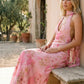 Aleena cowl neck halter maxi dress with a deep draped neckline, fitted halter strap, open back with tie-neck closure, sleeveless column silhouette, and floor-length straight hem in a smooth, elegant finish.