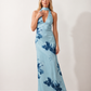 Aleena cowl neck halter maxi dress with a deep draped neckline, fitted halter strap, open back with tie-neck closure, sleeveless column silhouette, and floor-length straight hem in a smooth, elegant finish.
