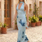Aleena cowl neck halter maxi dress with a deep draped neckline, fitted halter strap, open back with tie-neck closure, sleeveless column silhouette, and floor-length straight hem in a smooth, elegant finish.