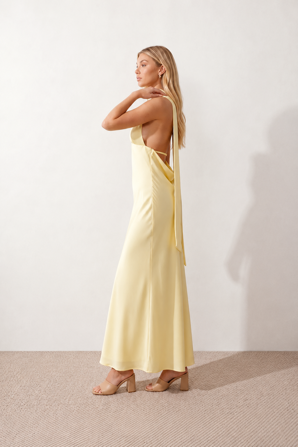 Aleena cowl neck halter maxi dress with a deep draped neckline, fitted halter strap, open back with tie-neck closure, sleeveless column silhouette, and floor-length straight hem in a smooth, elegant finish.