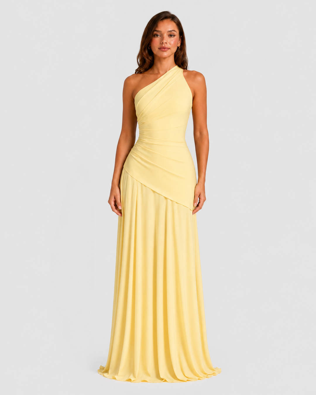 Woman wearing a one-shoulder chiffon maxi dress featuring a pleated neckline, corset bodice with lace-up back, and flowing godet skirt in an elegant formal silhouette.