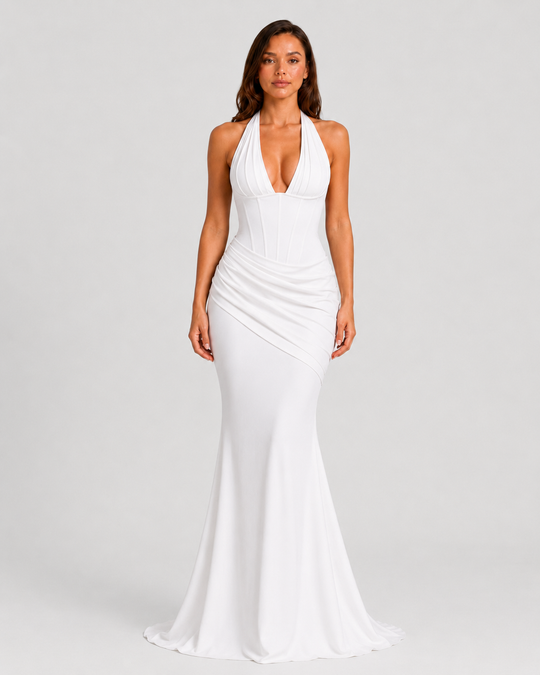 Women's halter corset evening gown featuring a plunge neckline, structured boned bodice, asymmetric pleated draped skirt detail, lace-up back, and softly flared crepe silhouette.
