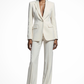 Woman wearing a white suit on a white background