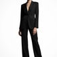 Woman wearing a black suit on a white background