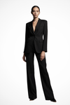 Woman wearing a black suit on a white background