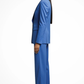 Woman wearing a blue suit standing against a white background