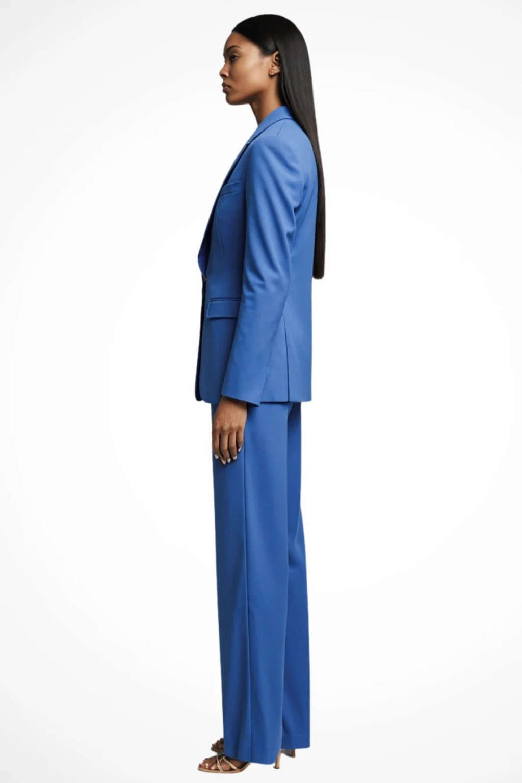 Woman wearing a blue suit standing against a white background