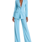 Woman wearing a light blue suit on a white background