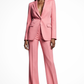 Woman wearing a pink suit on a white background
