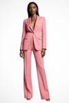 Woman wearing a pink suit on a white background