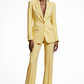 Woman wearing a yellow suit on a white background