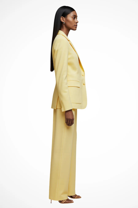 Woman wearing a yellow suit on a white background