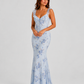 Woman wearing a floral maxi dress with delicate ruffle straps, slim-fit silhouette, flowing lightweight fabric, and romantic summer styling.