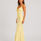Woman wearing a floral maxi dress with delicate ruffle straps, slim-fit silhouette, flowing lightweight fabric, and romantic summer styling.