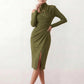 Woman wearing the Asymmetric Neck Open Back Midi Dress featuring an asymmetric mock-neck halter, off-shoulder ruched detailing, long fitted sleeves, an elegant open back, fitted midi silhouette and front slit, styled for weddings, cocktail parties and formal occasions.