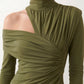 Woman wearing the Asymmetric Neck Open Back Midi Dress featuring an asymmetric mock-neck halter, off-shoulder ruched detailing, long fitted sleeves, an elegant open back, fitted midi silhouette and front slit, styled for weddings, cocktail parties and formal occasions.