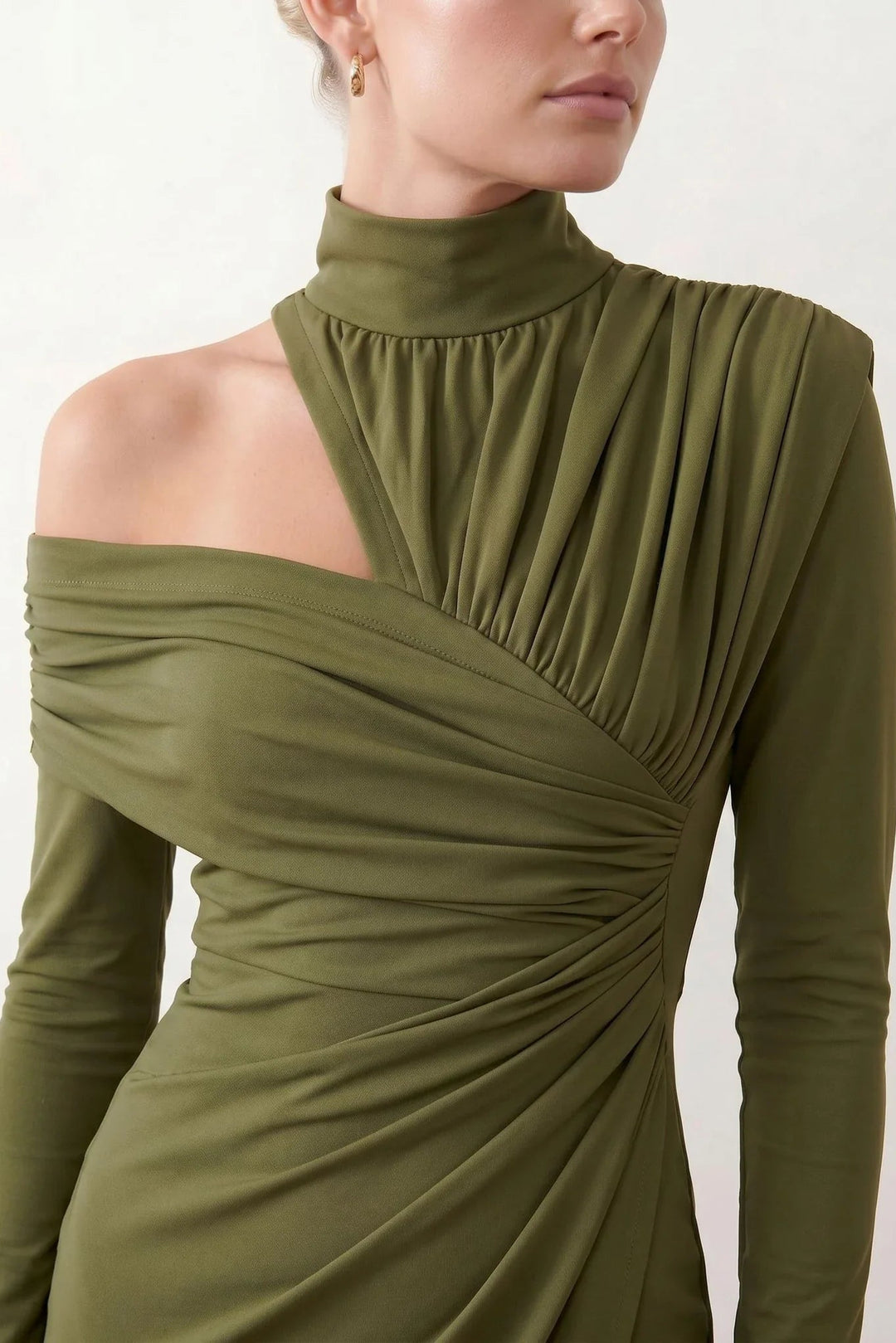 Woman wearing the Felisa Asymmetric Neck Open Back Midi Dress featuring an asymmetric mock-neck halter, off-shoulder ruched detailing, long fitted sleeves, an elegant open back, fitted midi silhouette and front slit, styled for weddings, cocktail parties and formal occasions.