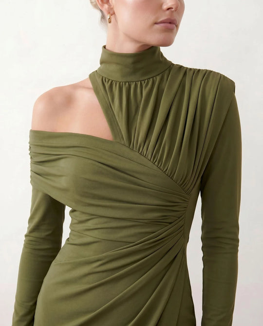 Woman wearing the Felisa Asymmetric Neck Open Back Midi Dress featuring an asymmetric mock-neck halter, off-shoulder ruched detailing, long fitted sleeves, an elegant open back, fitted midi silhouette and front slit, styled for weddings, cocktail parties and formal occasions.