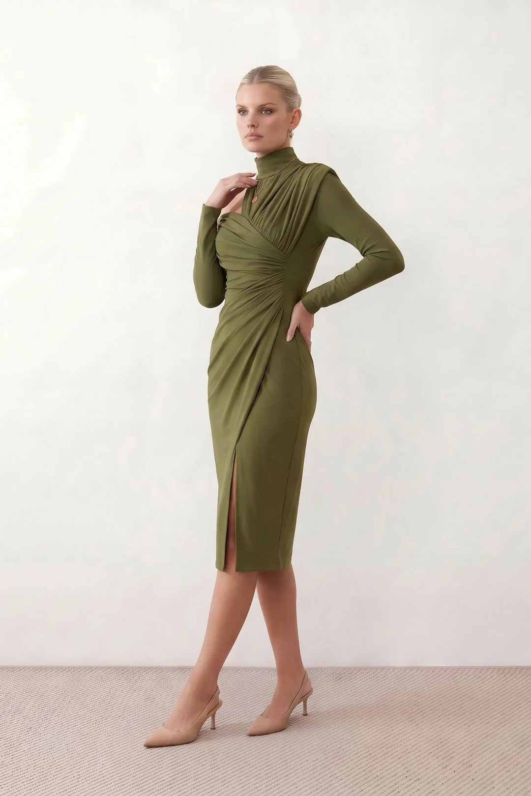 Woman wearing the Felisa Asymmetric Neck Open Back Midi Dress featuring an asymmetric mock-neck halter, off-shoulder ruched detailing, long fitted sleeves, an elegant open back, fitted midi silhouette and front slit, styled for weddings, cocktail parties and formal occasions.