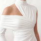 Woman wearing the Asymmetric Neck Open Back Midi Dress featuring an asymmetric mock-neck halter, off-shoulder ruched detailing, long fitted sleeves, an elegant open back, fitted midi silhouette and front slit, styled for weddings, cocktail parties and formal occasions.