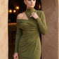 Woman wearing the Asymmetric Neck Open Back Midi Dress featuring an asymmetric mock-neck halter, off-shoulder ruched detailing, long fitted sleeves, an elegant open back, fitted midi silhouette and front slit, styled for weddings, cocktail parties and formal occasions.