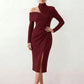 Woman wearing the Asymmetric Neck Open Back Midi Dress featuring an asymmetric mock-neck halter, off-shoulder ruched detailing, long fitted sleeves, an elegant open back, fitted midi silhouette and front slit, styled for weddings, cocktail parties and formal occasions.